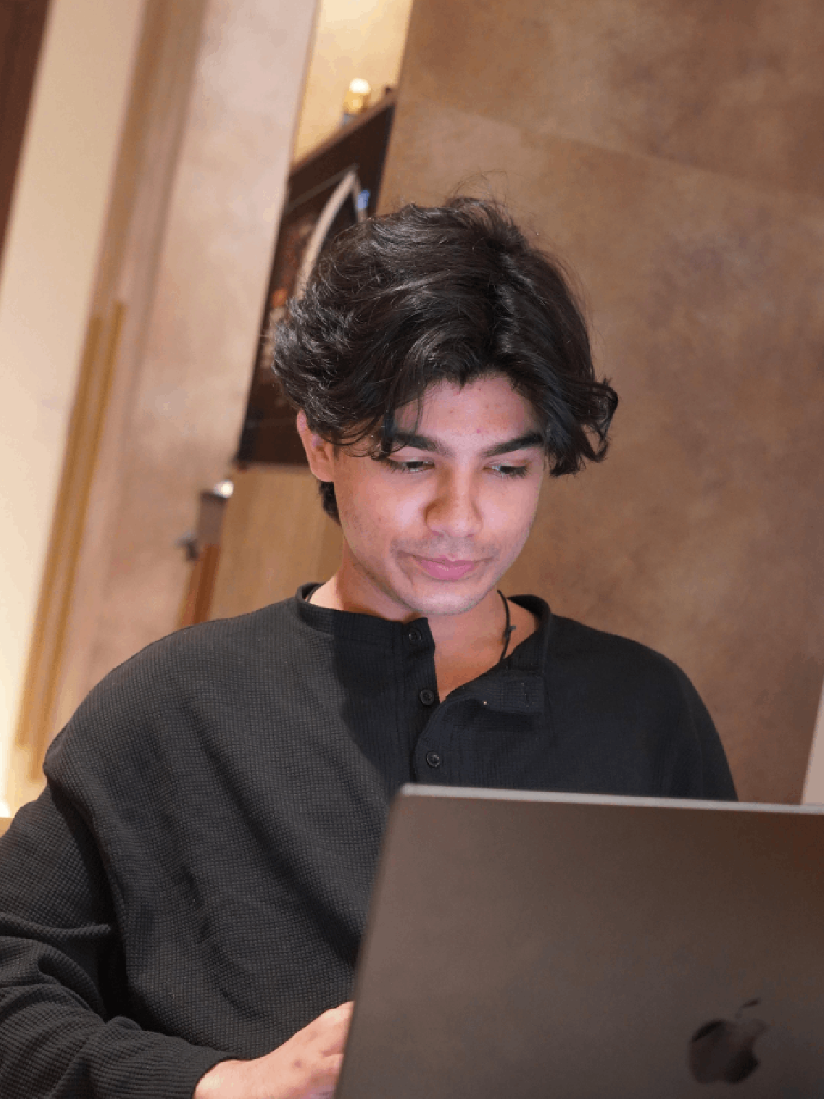 Umar Khan working on a laptop